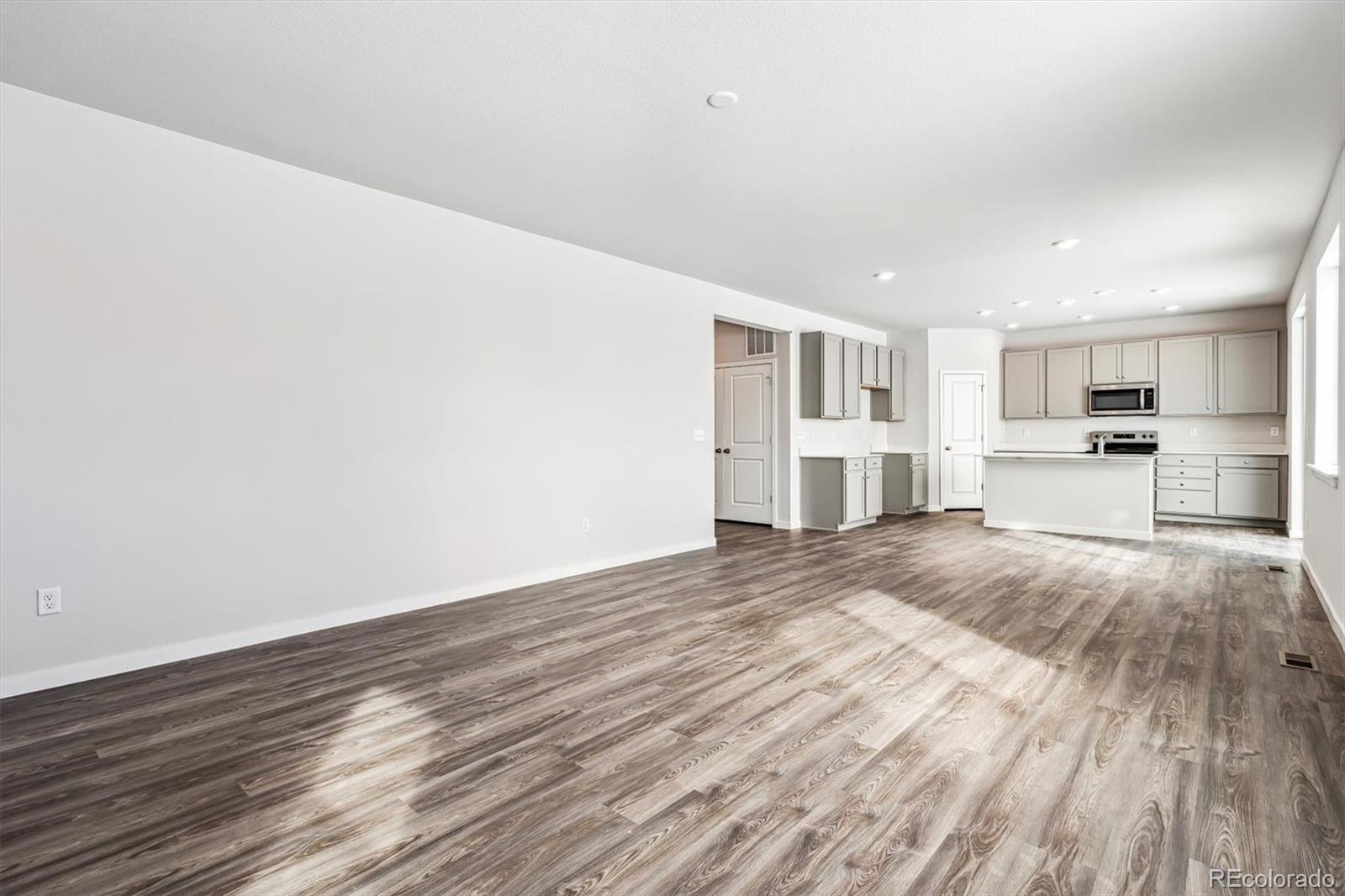 5680 Ranch Street Mead, CO 80504 - Photo 9 of 23 a view of kitchen with wooden floor and window
