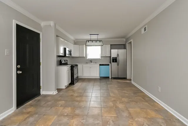 a view of a kitchen with a sink and stainless steel appliances