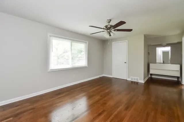wooden floor in an empty room with a window