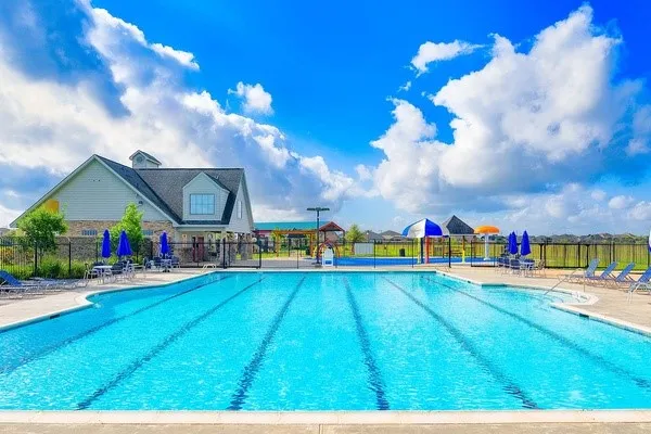 a view of an house with swimming pool and sitting area