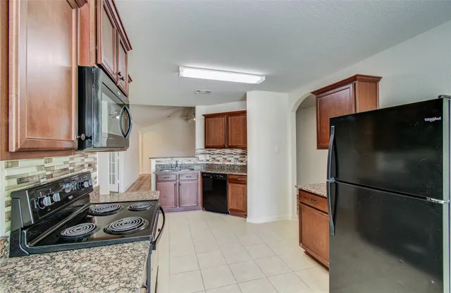 a kitchen with a refrigerator stove and sink