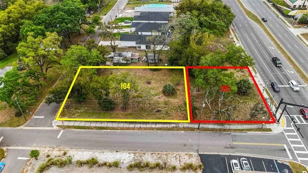 an aerial view of a house with a yard and garden