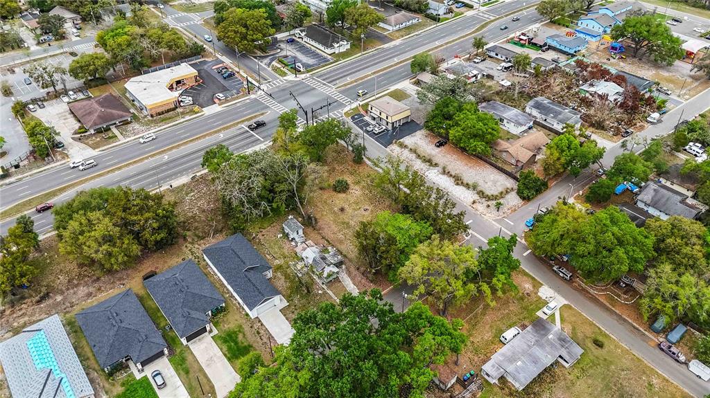 105 North Kirkman Road Orlando, FL 32811 - Photo 6 of 10 an aerial view of a house with a yard and garden