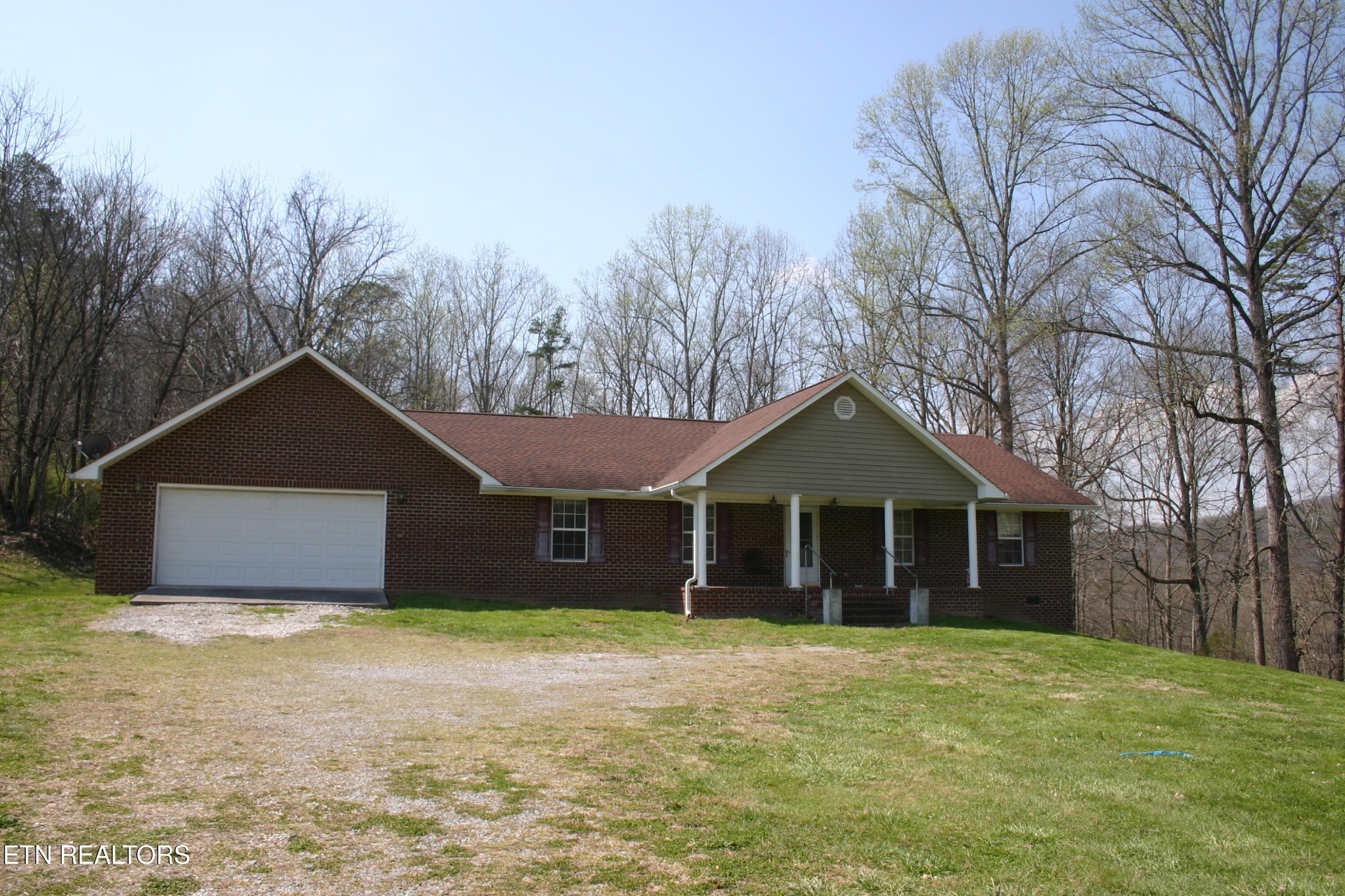 163 Upper Clear Creek Road Andersonville, TN 37705 - Photo 1 of 15 a front view of a house with a garden and trees