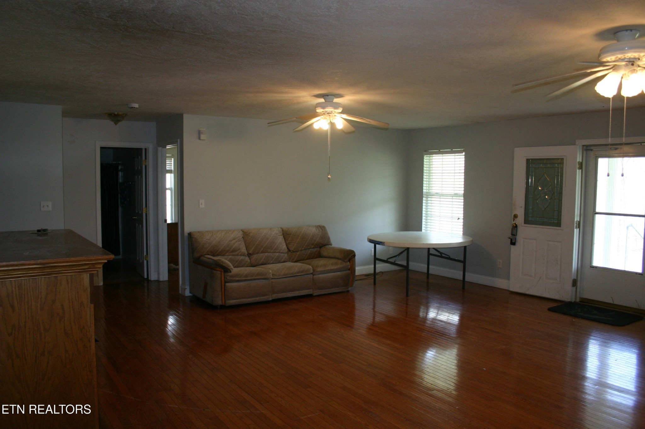 163 Upper Clear Creek Road Andersonville, TN 37705 - Photo 11 of 15 a living room with furniture and a wooden floor