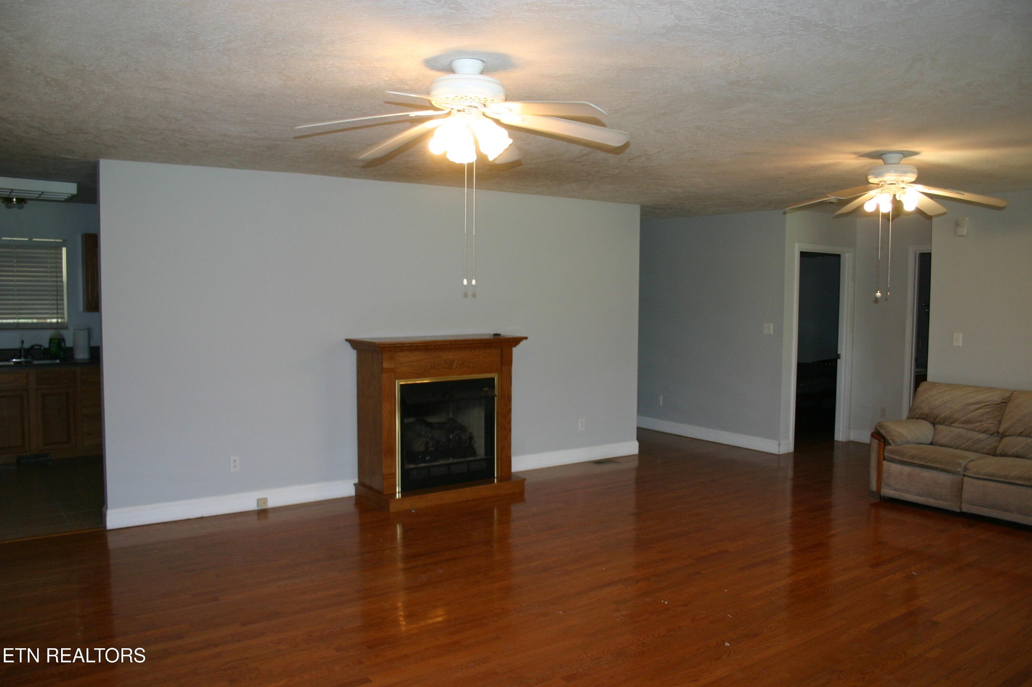 163 Upper Clear Creek Road Andersonville, TN 37705 - Photo 4 of 15 a view of a livingroom with a fireplace a chandelier and wooden floor