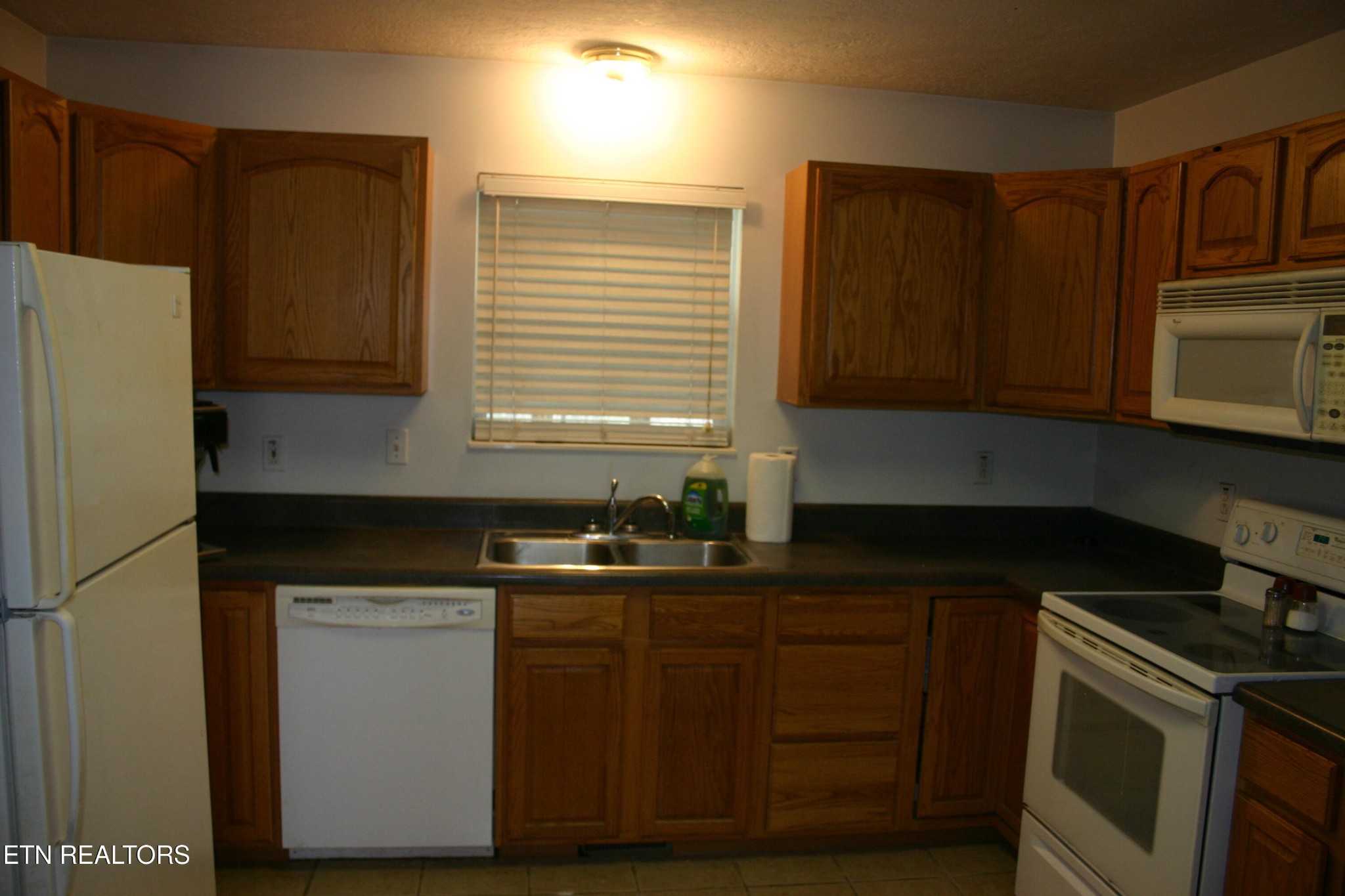 163 Upper Clear Creek Road Andersonville, TN 37705 - Photo 6 of 15 a kitchen with granite countertop wooden cabinets and a stove top oven