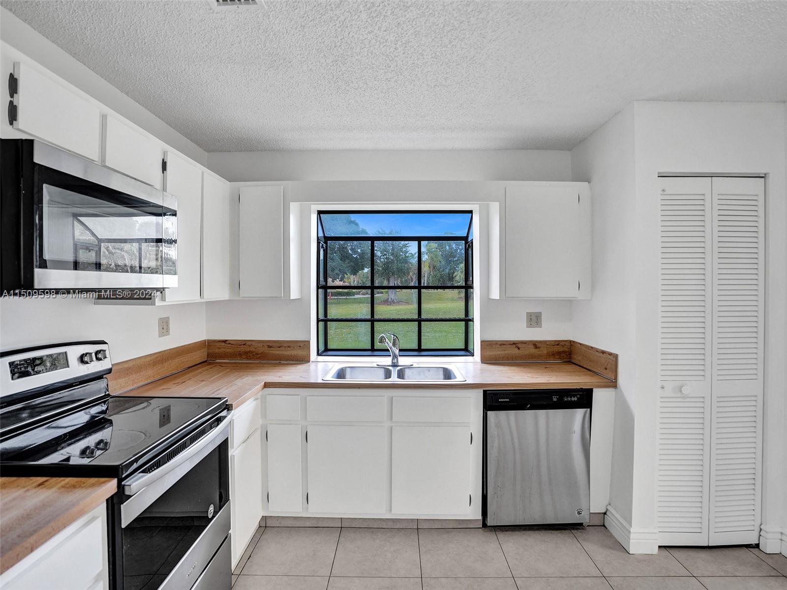 19621 Back 9 Drive Boca Raton, FL 33498 - Photo 13 of 45 a kitchen that has a sink and a stove