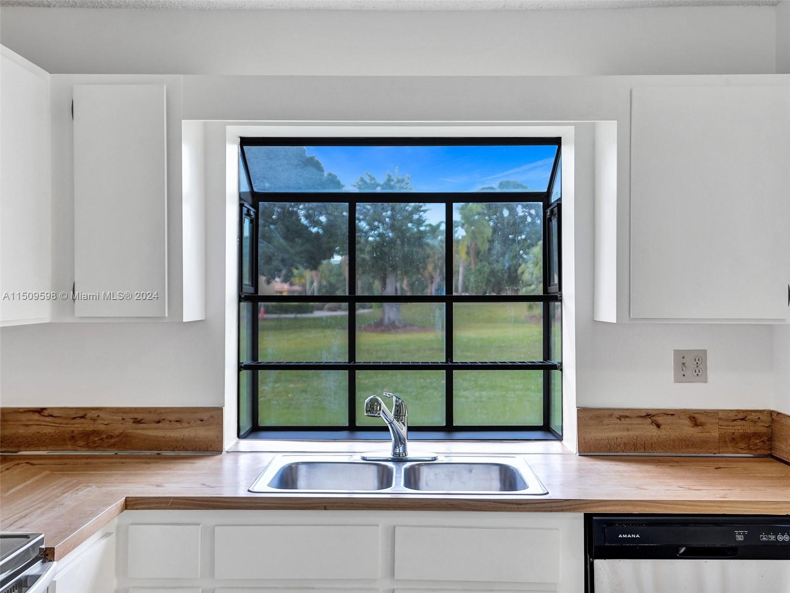 19621 Back 9 Drive Boca Raton, FL 33498 - Photo 14 of 45 a kitchen with a sink and a window