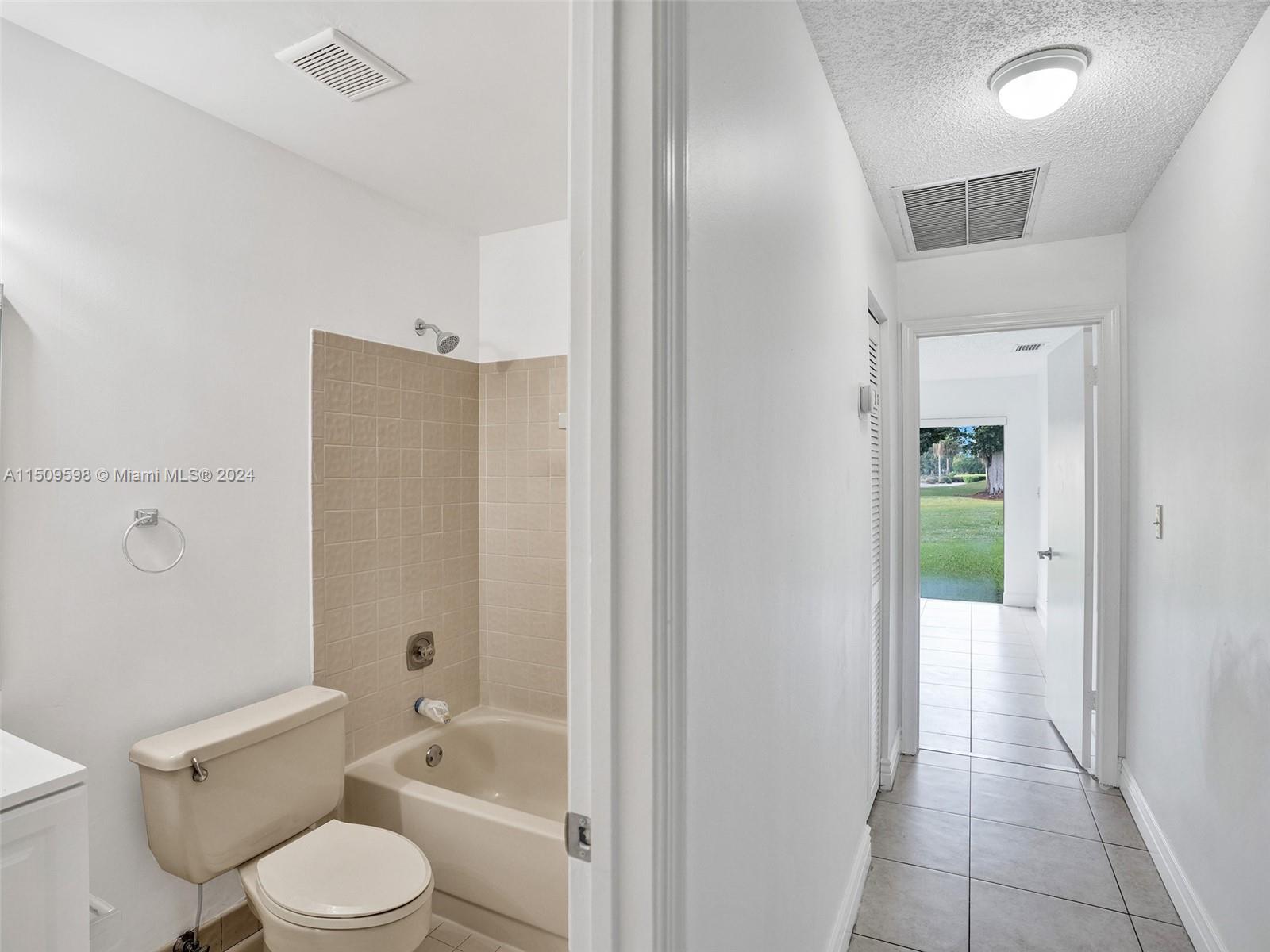 19621 Back 9 Drive Boca Raton, FL 33498 - Photo 19 of 45 a bathroom with a toilet a sink and bathtub