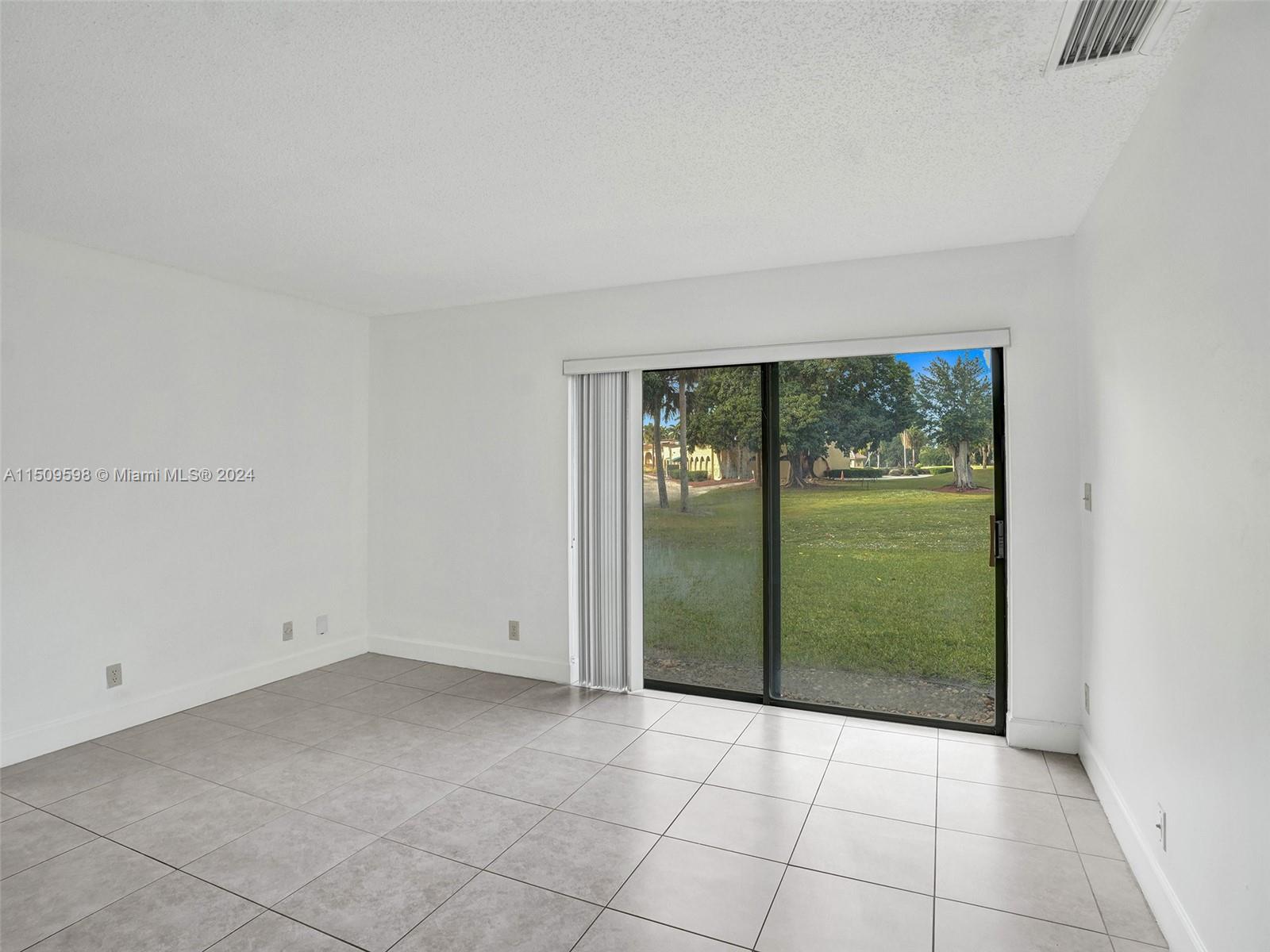 19621 Back 9 Drive Boca Raton, FL 33498 - Photo 21 of 45 an empty room with sliding glass door and shower