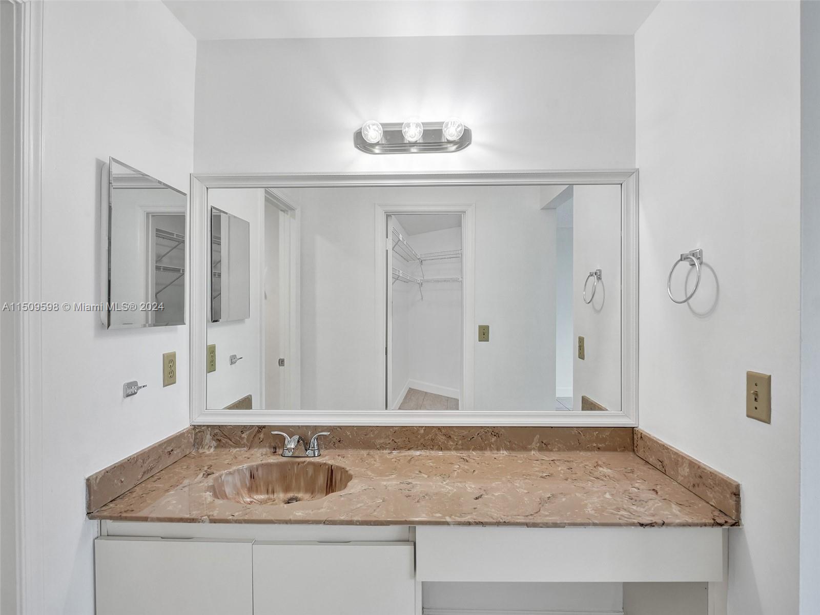 19621 Back 9 Drive Boca Raton, FL 33498 - Photo 26 of 45 a bathroom with granite countertop a sink and a mirror