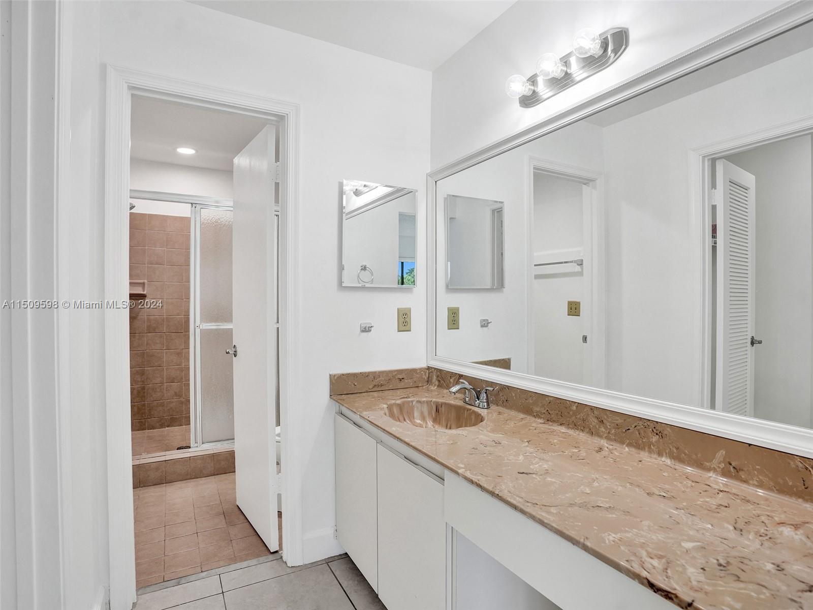 19621 Back 9 Drive Boca Raton, FL 33498 - Photo 27 of 45 a bathroom with a granite countertop sink and a mirror