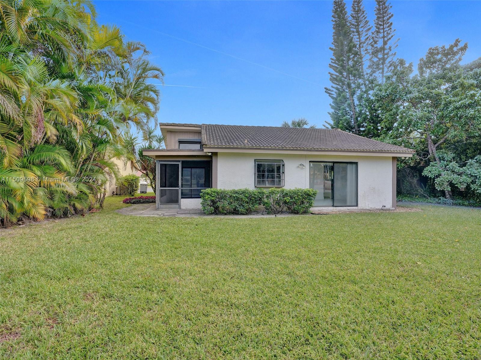 19621 Back 9 Drive Boca Raton, FL 33498 - Photo 36 of 45 a front view of a house with a garden