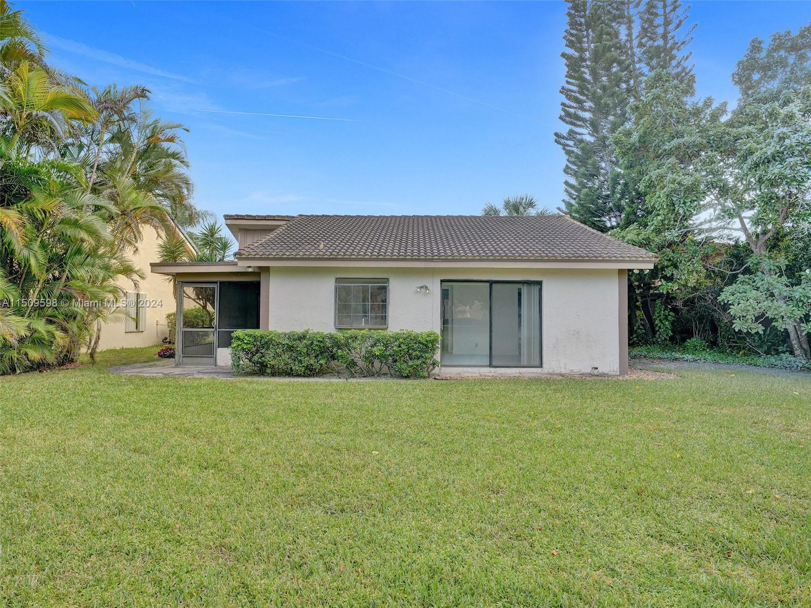 19621 Back 9 Drive Boca Raton, FL 33498 - Photo 37 of 45 a front view of a house with a garden