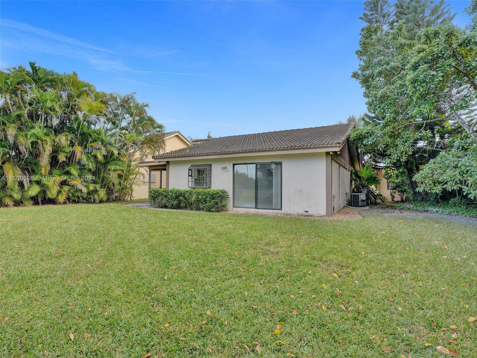 19621 Back 9 Drive Boca Raton, FL 33498 - Photo 38 of 45 a view of a house with backyard and garden
