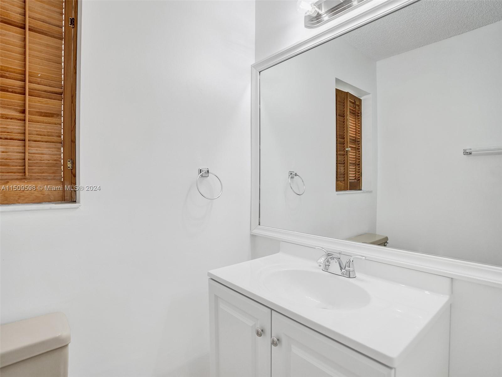19621 Back 9 Drive Boca Raton, FL 33498 - Photo 41 of 45 a bathroom with a sink and a mirror