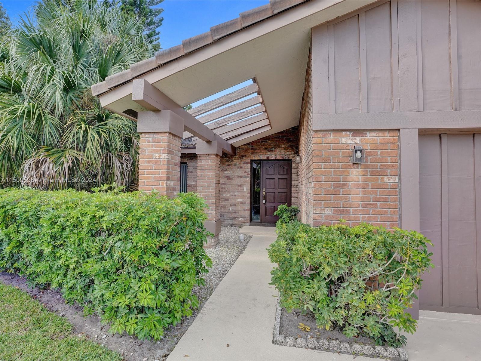 19621 Back 9 Drive Boca Raton, FL 33498 - Photo 45 of 45 a front view of a house with garden