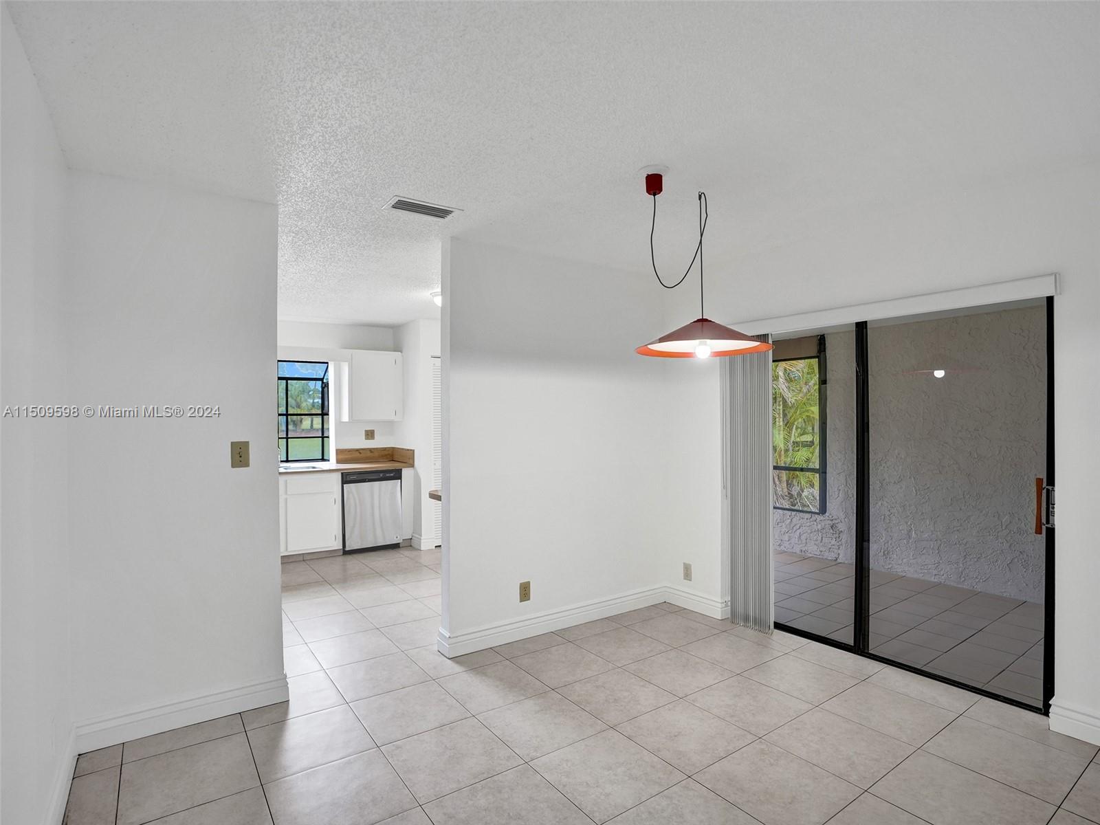 19621 Back 9 Drive Boca Raton, FL 33498 - Photo 10 of 45 a dining room with kitchen view