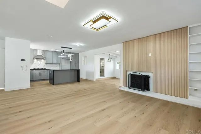 a view of a kitchen with a sink and a fireplace