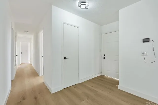 a view of a room with wooden floor