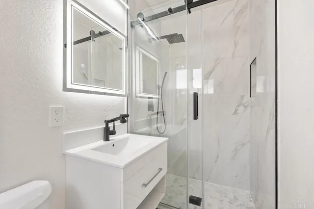 a bathroom with a sink toilet and shower