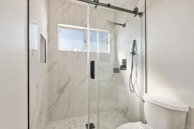 a bathroom with a glass shower door
