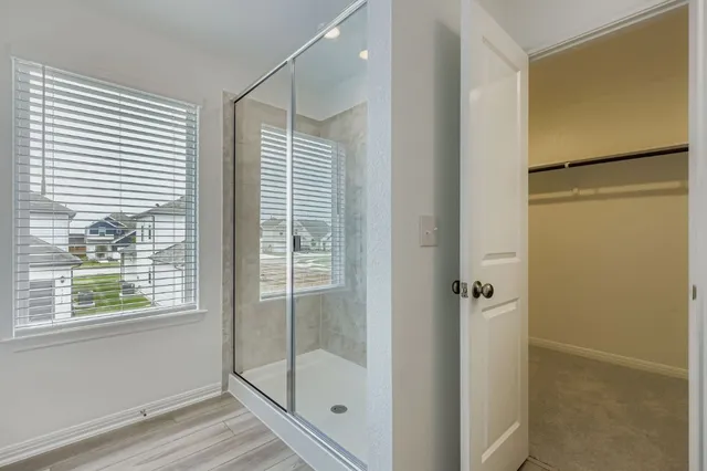 a bathroom with a glass shower door