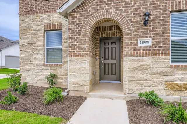 a view of entrance of the house with potted plants