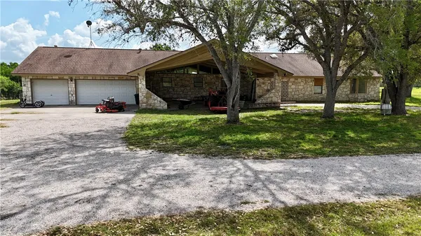 a view of a house with a backyard