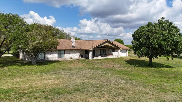 a front view of house with yard and green space