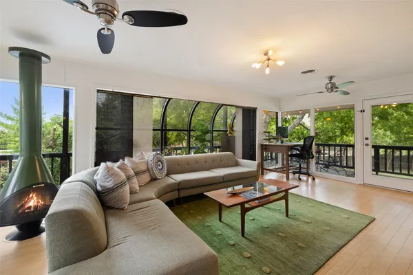 a living room with furniture and a floor to ceiling window