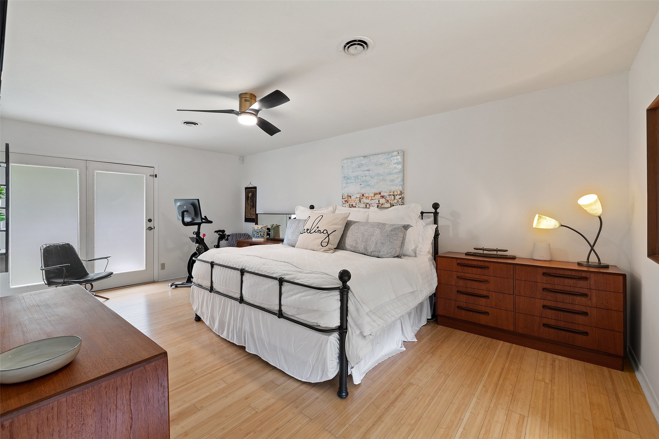 1712 McCoy Place Georgetown, TX 78626 - Photo 19 of 34 a spacious bedroom with a bed and wooden floor