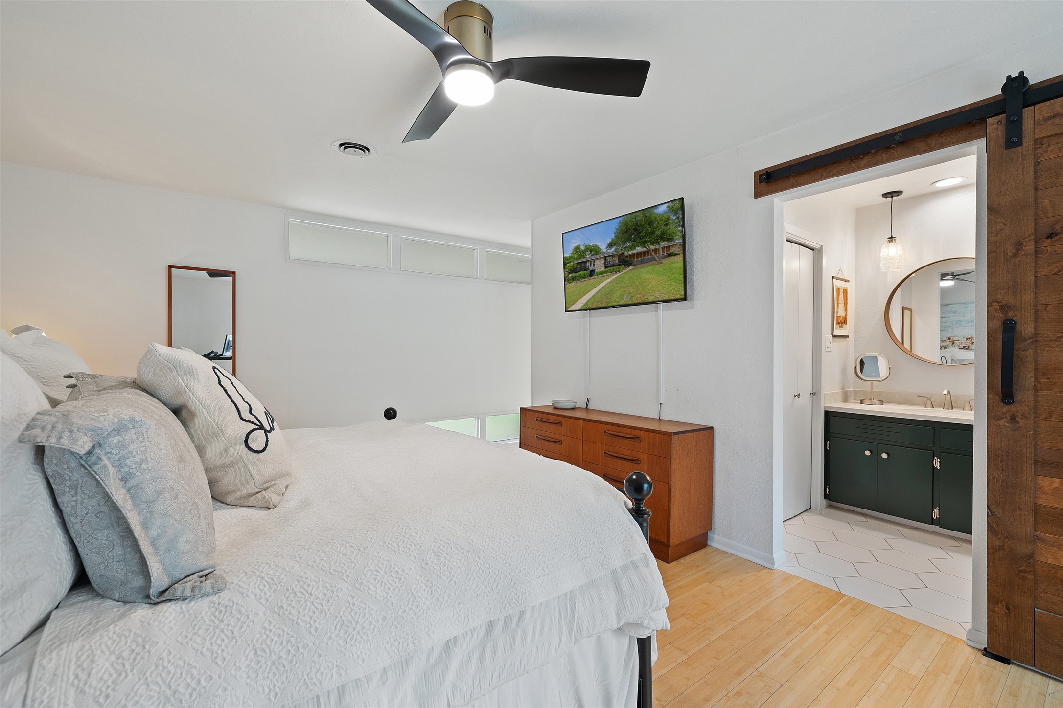 1712 McCoy Place Georgetown, TX 78626 - Photo 20 of 34 a bedroom with a bed and a chandelier