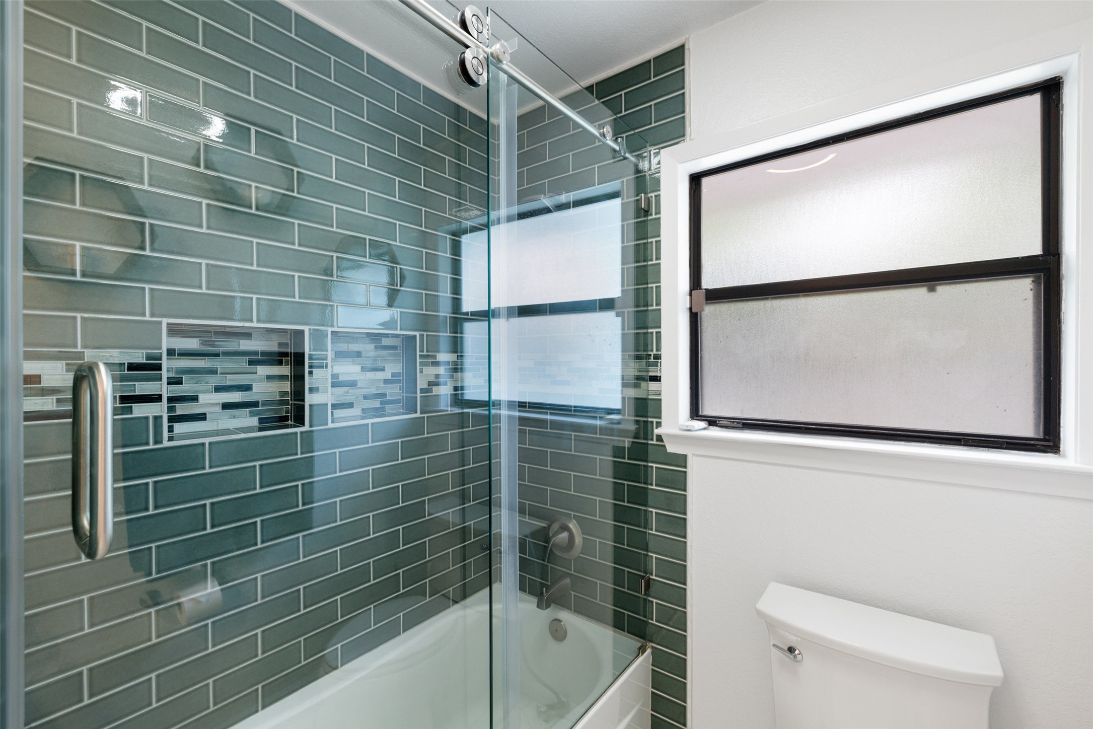 1712 McCoy Place Georgetown, TX 78626 - Photo 23 of 34 a bathroom with a shower and a toilet