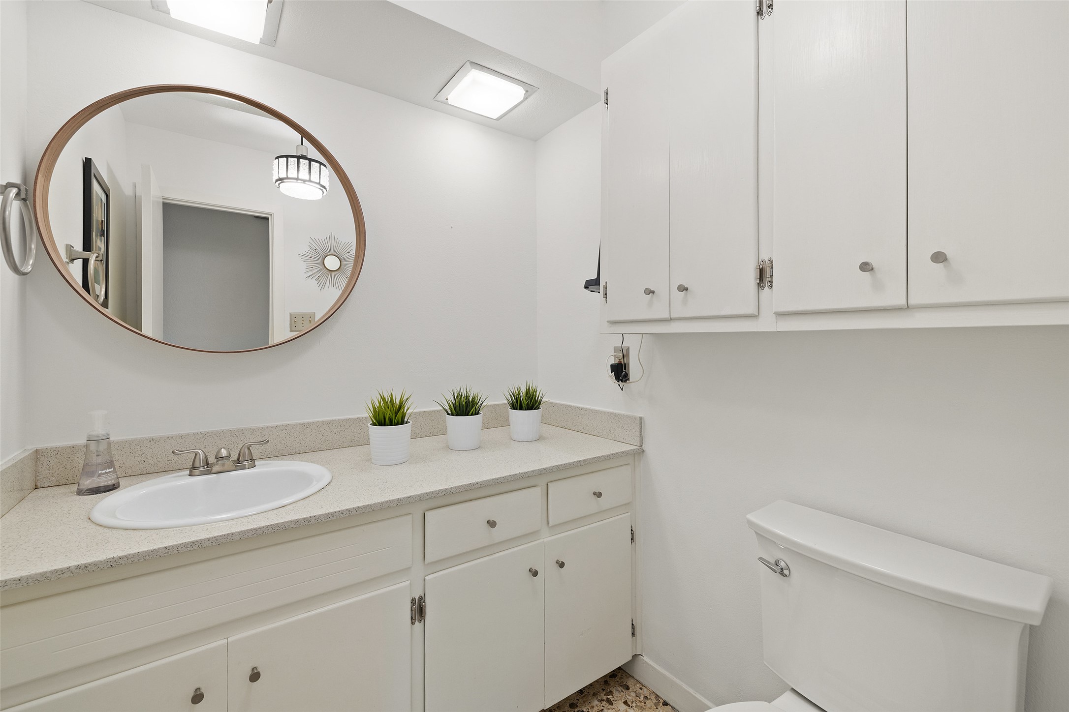 1712 McCoy Place Georgetown, TX 78626 - Photo 29 of 34 a bathroom with a granite countertop toilet a sink and mirror