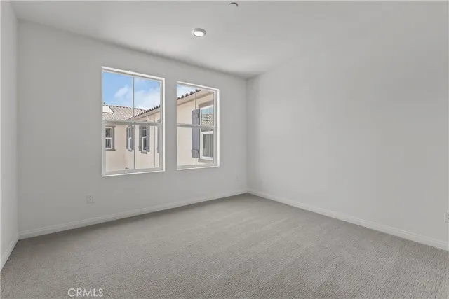 a view of an empty room with windows