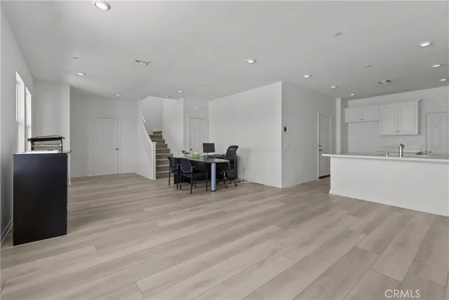 a view of kitchen with furniture and refrigerator