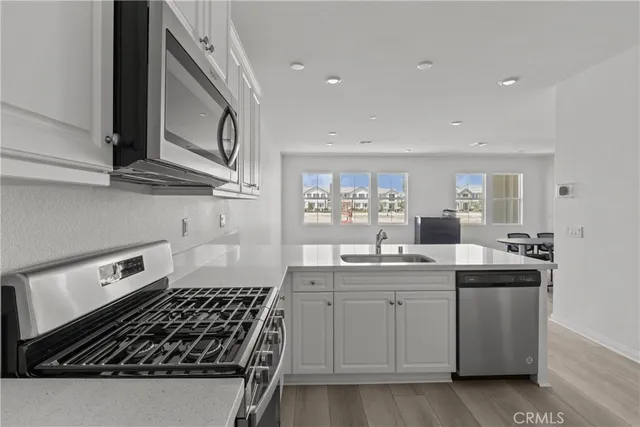 a kitchen with cabinets and stove