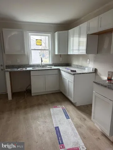 a kitchen with granite countertop a sink and a stove
