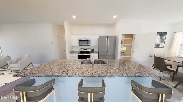 a kitchen with a refrigerator and a stove