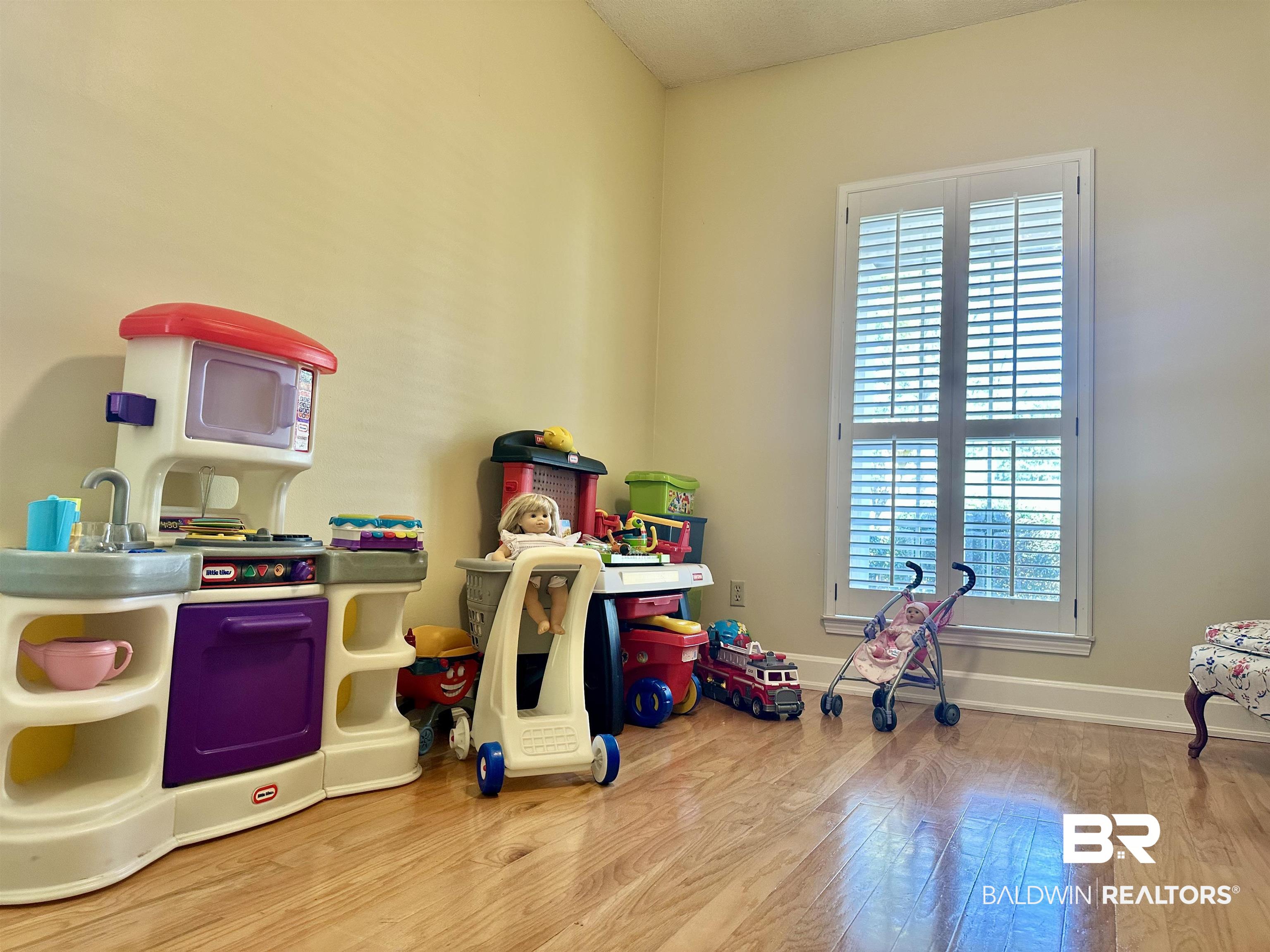 148 Brooks Boulevard Brewton, AL 36426 - Photo 33 of 45 Rec room featuring a healthy amount of sunlight, baseboards, and wood finished floors