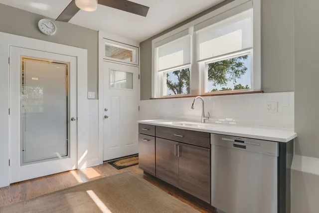 a view with cabinets a sink and a window