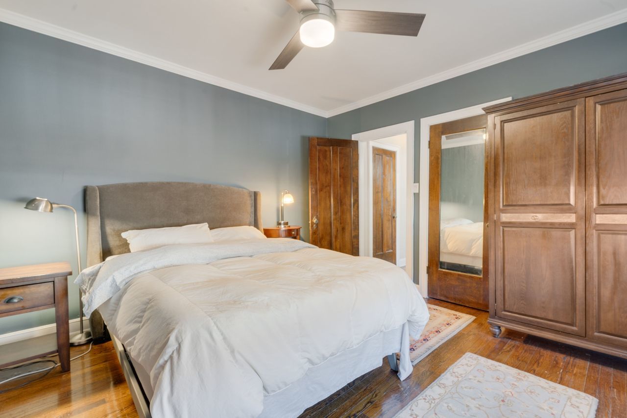 1217 Hull Terrace, Unit 3A Evanston, IL 60202 - Photo 15 of 28 a bedroom with a bed and a chandelier