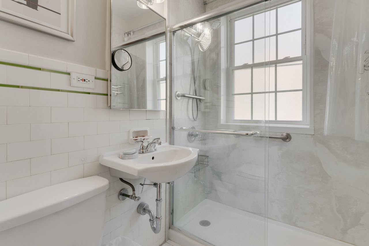 1217 Hull Terrace, Unit 3A Evanston, IL 60202 - Photo 20 of 28 a bathroom with a sink a toilet and shower
