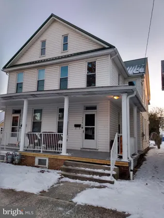 a view of a house with a stairs and a yard