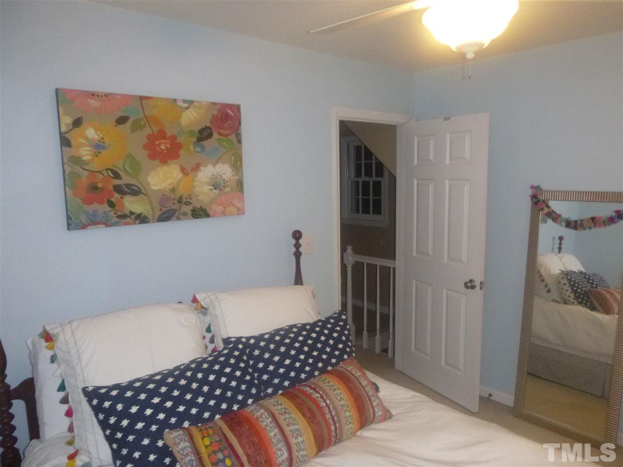 4905 Kinross Court Raleigh, NC 27613 - Photo 22 of 25 a bedroom with a bed and wooden floor
