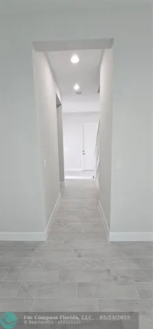 a view of hallway with wooden floor