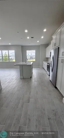 a view of a hall with wooden floor