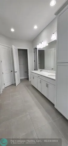 a view of an empty room with a kitchen